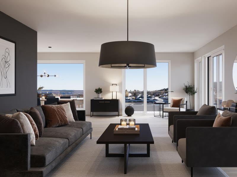 Bilde fra boligprosjektet Strømmen Verksted. Stue med grå sofa, stuebord i mørkt tre og beige teppe på gulvet. En lekker taklampe henger fra taket og i bakgrunnen ser man ut gjennom verandadøren med fin utsikt og mye dagslys kommer inn.