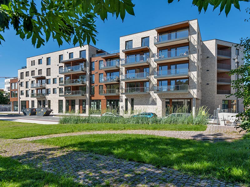 Bilde av boligprosjektet Wessel Park, boligblokkene syntes i bakgrunnen av en koselig park i koselig vinterlandskap. 