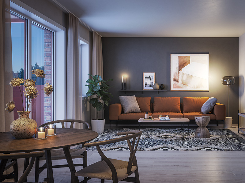 Stue i kveldslys med spisebord i forgrunn og rustrød sofa i midten. Illustrasjonsbilde til artikkel om interiørtips til drømmehjemmet.
